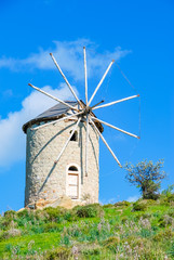 Fototapeta na wymiar View of Windmills and Sunny sky at the hill of Foca Town in Izmir.