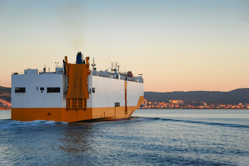 Large RORO ship or oceangoing vehicle carrier ship sailing in the sea.