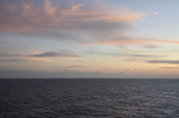 Sunset over the sea, view from the sailing ship.