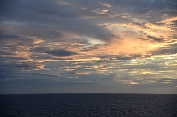 Fototapeta premium Sunset over the sea, view from the sailing ship.