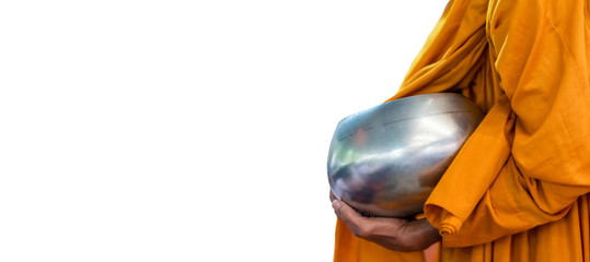 White background and copy space with clipping path of a Buddhist monk is holding his arms bowl walking to receive food that offering from Buddhist in the early morning. 