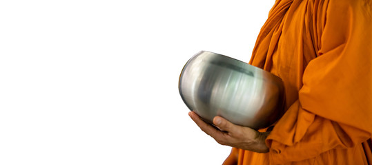 White background and copy space with clipping path of a Buddhist monk is holding his arms bowl walking to receive food that offering from Buddhist in the early morning. 