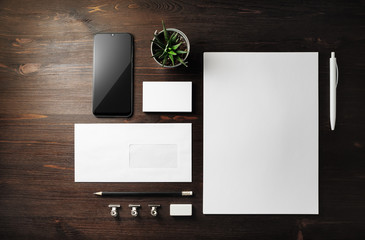 Blank corporate stationery set on wood table background. Template for branding design. Branding...