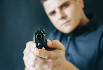 Man is holding gun in his hands. Criminal concept. Self defense and weapon legalising.