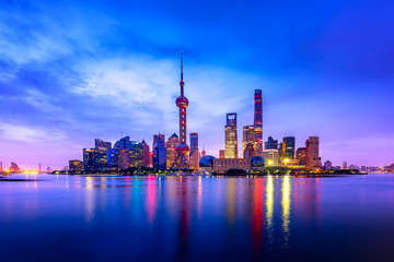 Cityscape of Shanghai at twilight sunset. Panoramic view of Pudong business district skyline from the Bund.