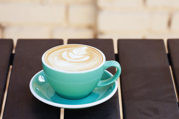 Coffee cup on wooden table. View from top. Copy space.