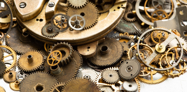Vintage gears macro view. Aged mechanical clock wheels background. Shallow depth of field, soft focus