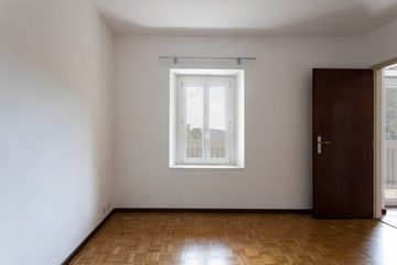 Fototapeta na wymiar Empty room with white walls and window overlooking nature