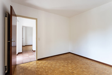 Empty room with white walls and open door