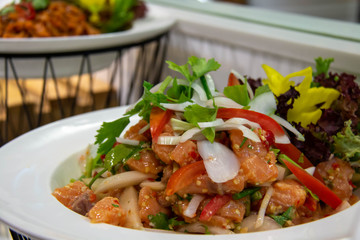  spicy salmon Thai salad on white plate