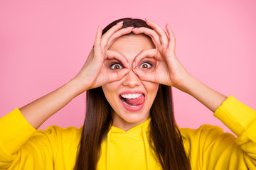 Closeup photo of charming cute nice attractive playful girlfriend wearing bright color yellow hoodie showing you two ok signs formed as glasses while isolated with pink pastel color background