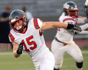 Young Athletic Teen Boy Playing in an American Football Game