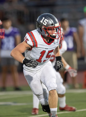 Young Athletic Teen Boy Playing in an American Football Game