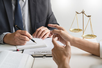 business people and lawyers discussing contract papers sitting at the table. Concepts of law,...