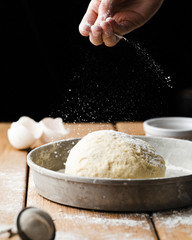 Front view of dough in tray on wooden table