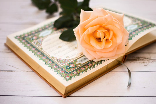 Quran - the holy book of Muslims. Roses.