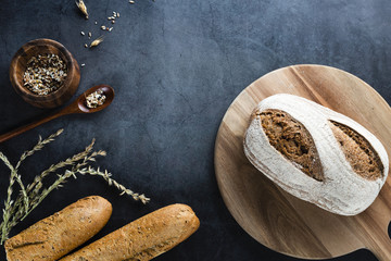 Top view of bread on chopper with black background