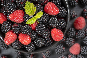 Background from fresh organic blackberries and raspberries, close up. Top view blackberry and raspberry