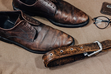 Brown leather retro shoes with strap glasses and a pocket watch. Vintage style.