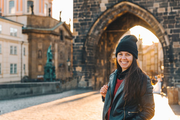 woman portrait at sunrise at charles bridge in prague