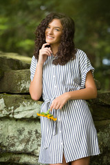 Fototapeta premium Teenage Girl High School Senior Brunette Smiing on Rocks