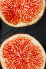 Ripe sweet figs on a black background.
