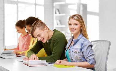 Obraz premium education, learning and people concept - happy high school students or classmates with books and notebooks