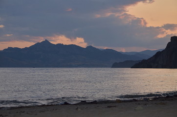 Fototapeta na wymiar Sunset in Quiet bay on Black sea, next to Koktebel. Crimea 