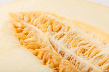 Big melon divided into slices. Seeds and pulp close-up