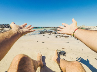 Summer holiday vacation and happiness concept with men eyes point of view of beautiful sandy beach and blue ocean water - happy people in outdoor leisure activity