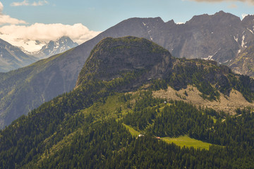 Elevated view of the Italian Alps from the Mont Blanc massif with the Mont Chetif peak (2343 m) covered with conifer forests in summer, Courmayeur, Aosta Valley, Italy