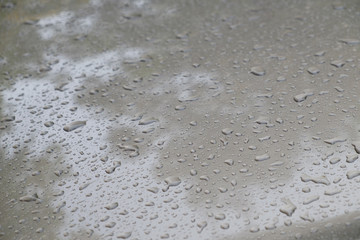 Small raindrops on a car, closeup