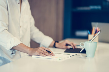 Fototapeta premium Portrait of casual young entrepreneur businessman working in modern work station.