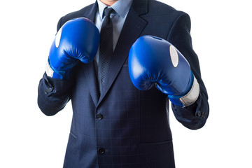 Young man in a suit and blue boxing gloves, isolated on white background