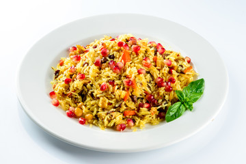 Uzbek pilaf with pomegranate on a white plate