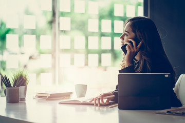 Portrait of beautiful smiling young  entrepreneur businesswoman working in modern work station.