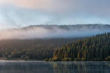Naklejka na ściany i meble Misty mountain lake after sunrise 