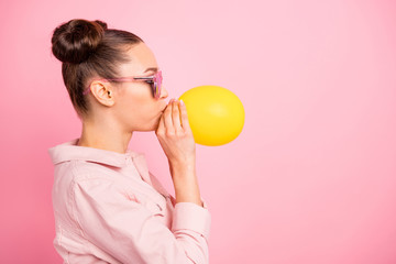 Profile side photo of lovely girl inflating balon wearing jacket isolated over pink background © deagreez
