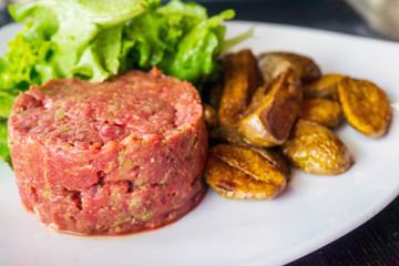 tasty Steak tartare (Raw beef) - classic steak tartare on white plate
