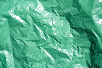 Green plastic garbage bag texture background. Waste recycling concept.