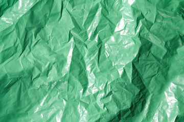 Green plastic garbage bag texture background. Waste recycling concept.