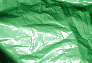 Fototapeta premium Green plastic garbage bag texture background. Waste recycling concept.