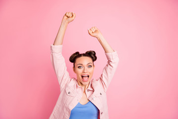 Fototapeta na wymiar Portrait of impressed woman raising her fists screaming yeah wearing jacket isolated over pink background
