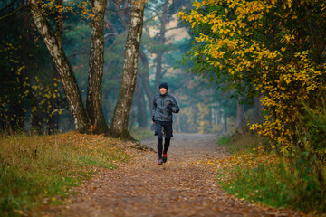 Obraz premium Photo of running athlete in autumn park