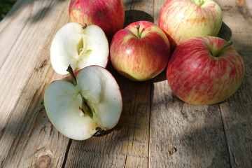 Red apples in basket on grey wooden background