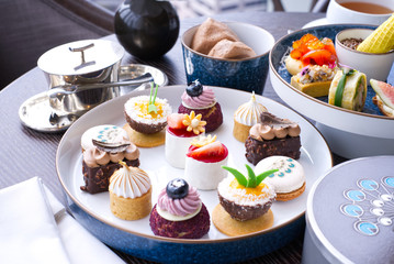The afternoon tea with sweet desserts on table in the restaurant