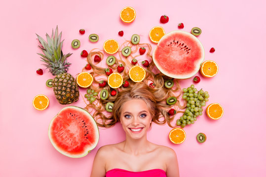 Close up top above high angle view photo beautiful she her lady lying down among different half slices fruits volume hair amazing pretty toothy beaming smiling isolated pink background