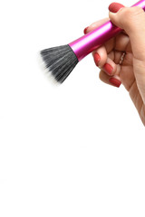 Isolated makeup brush in female hand on a white background