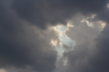 Fototapeta na wymiar dark cloud on sky with a little blue sky. concept : last chance, opportunity, dramatic sky, hope.