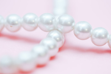 string of pearls delicate pink color, in soft focus, with highlights